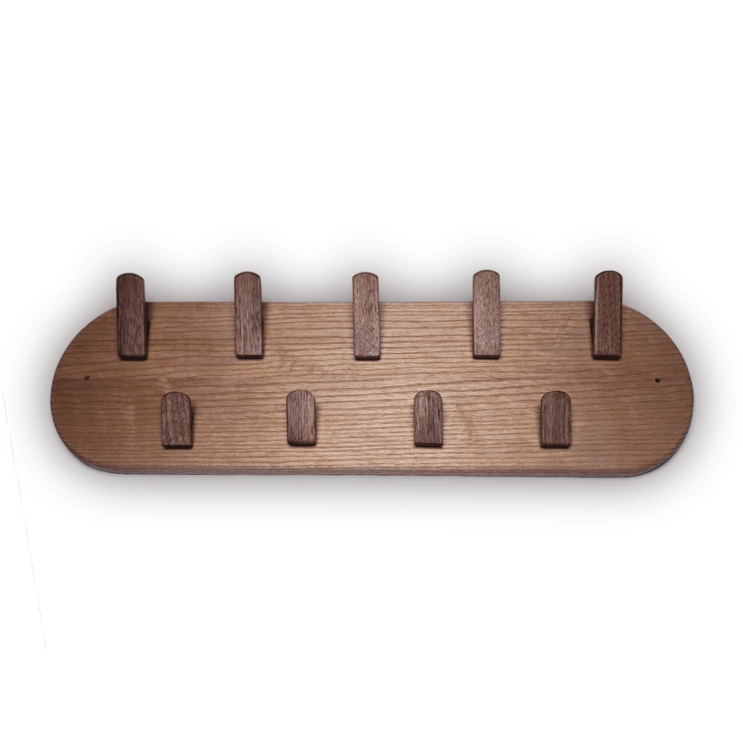 A wooden coat rack with upturned pegs
