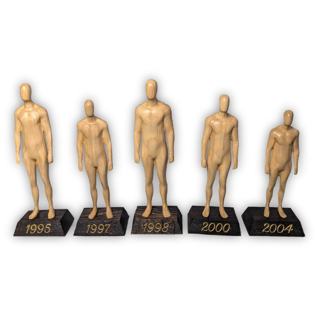 Five statuettes of varying heights, on black podiums engraved with dates in gold.